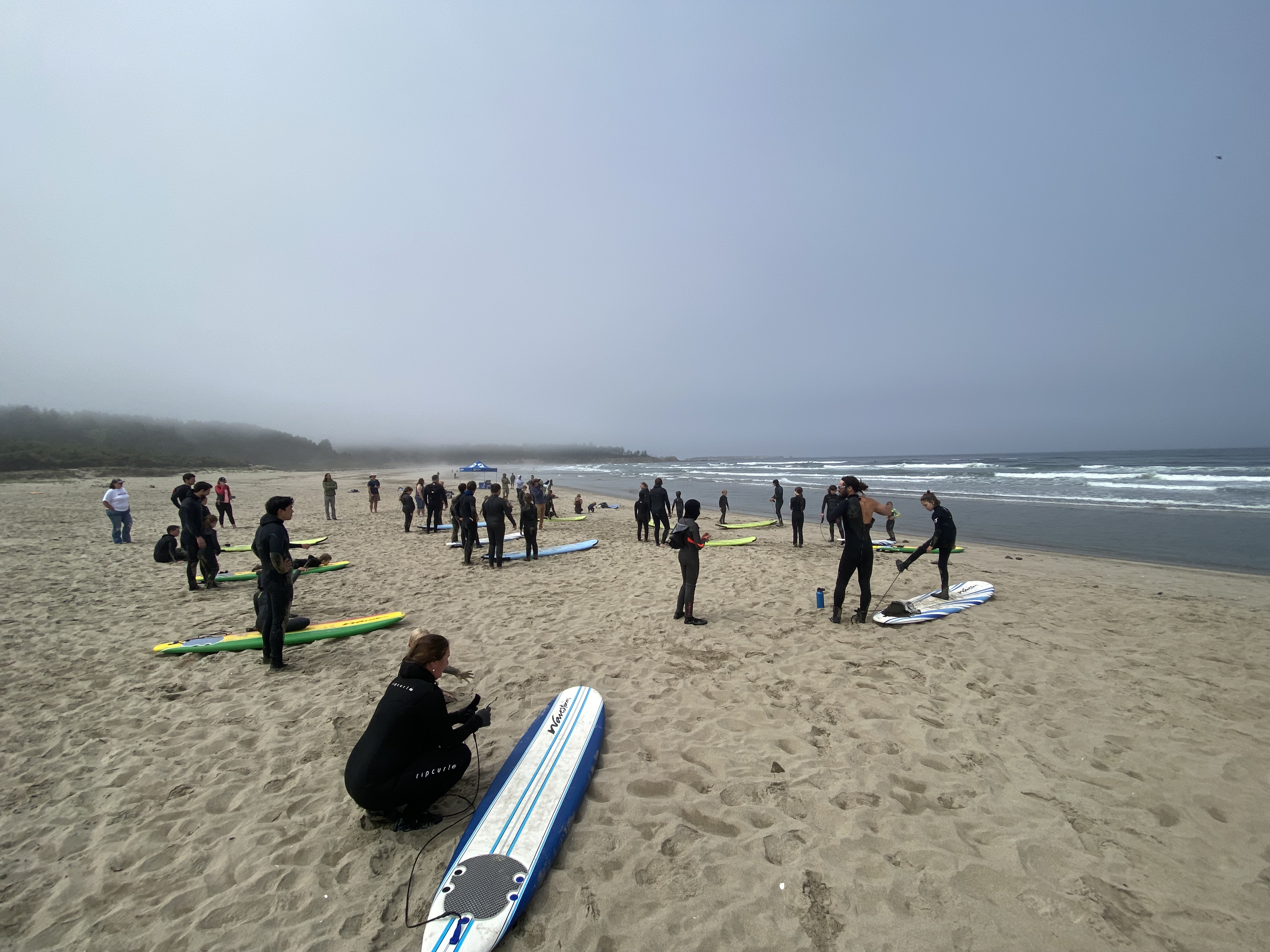 group of kids on the beach at surf camp in Coos Bay